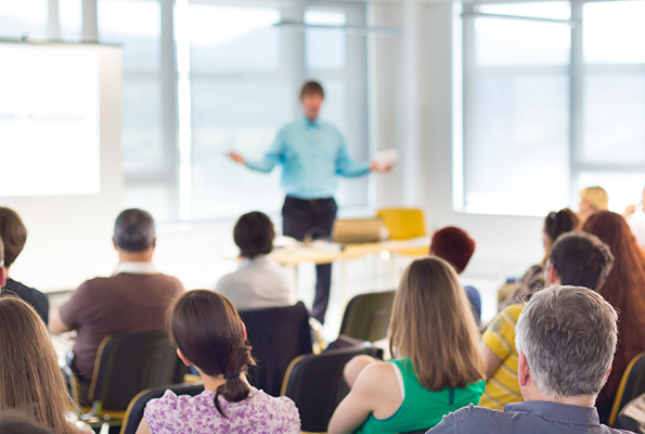 Speaker at business workshop and presentation. Audience at the conference room.