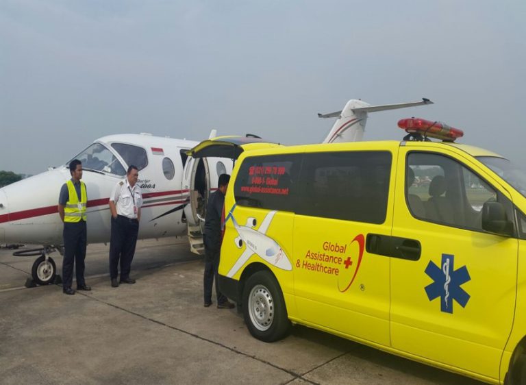 Global Assistance and Healthcare ambulance together with an aircraft - which are used to evacuate patients